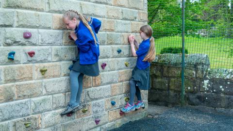 Two girls practicing on the climbing wall